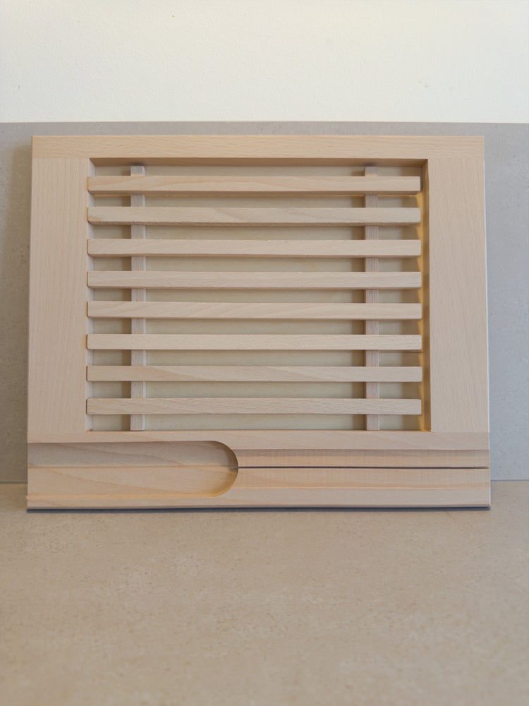 Bread cutting board with crumb catcher and knife holder