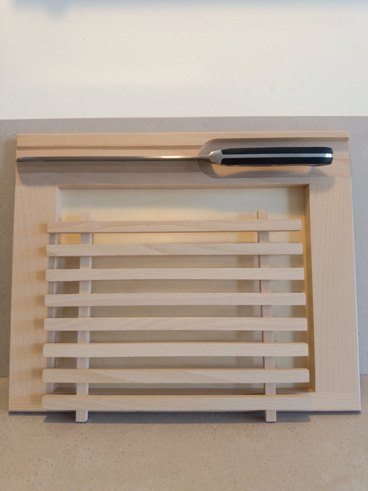 Bread cutting board with crumb catcher and knife holder